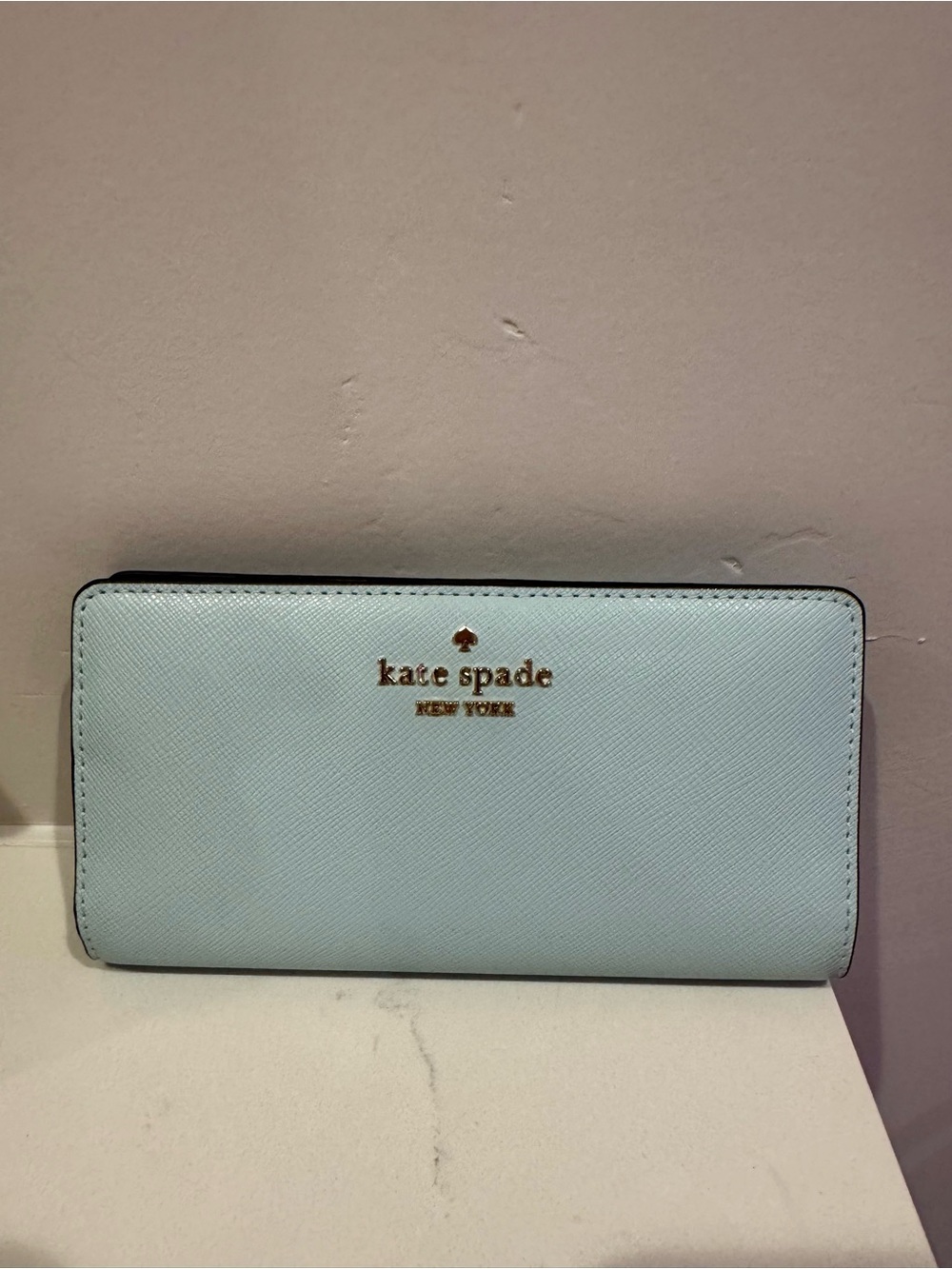 kate spade pale blue saffiano zip-around wallet with gold logo